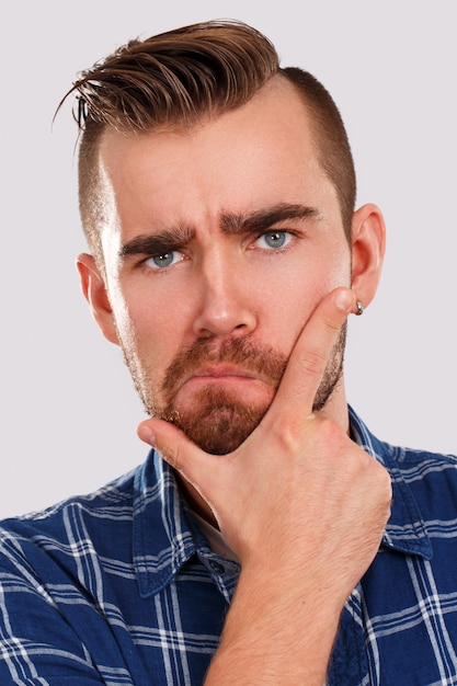 Emotions. Young man in blue shirt