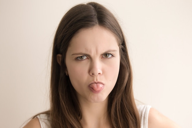 Emotive headshot portrait of offended young woman