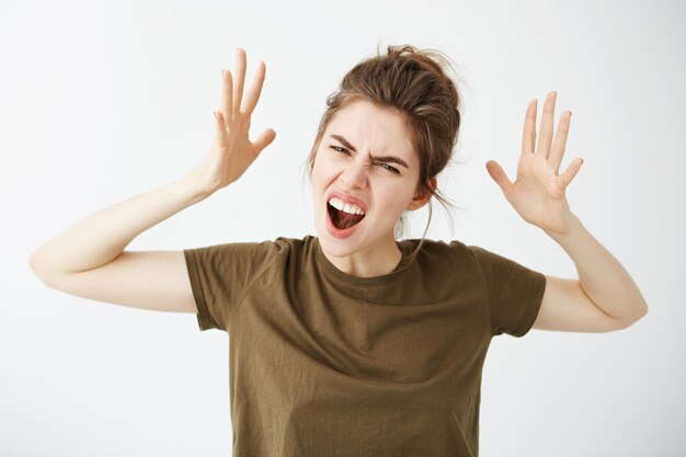 Emotive young attractive woman gesturing shouting.