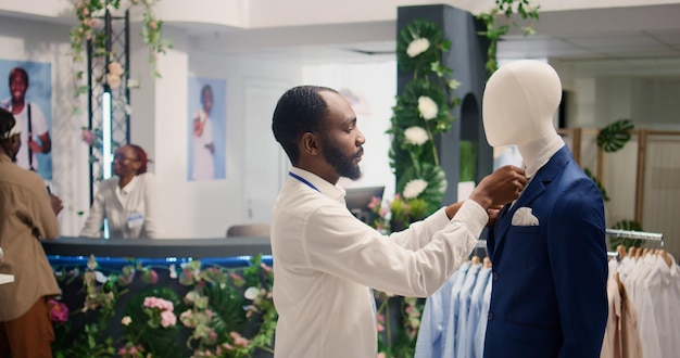 Free photo employee arranges blazer in thrift shop