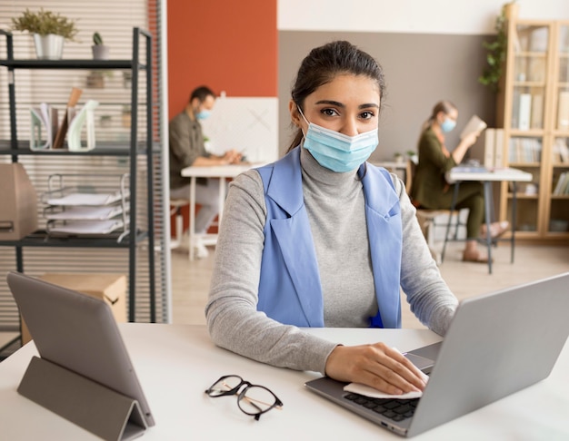 Employee disinfecting electronic device