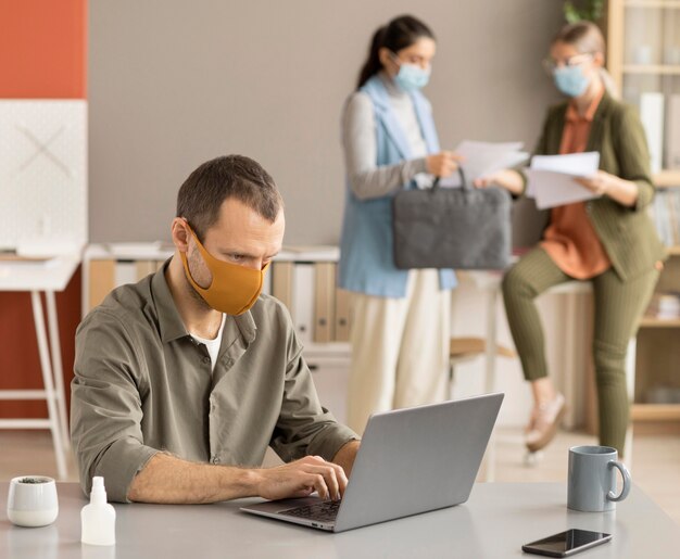 Employee disinfecting electronic device