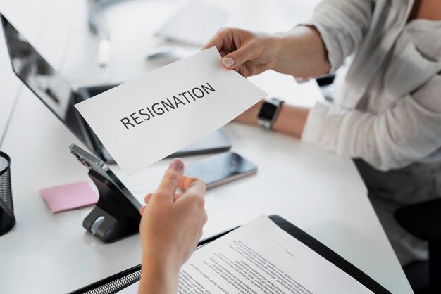 Employee holding resignation letter high angle