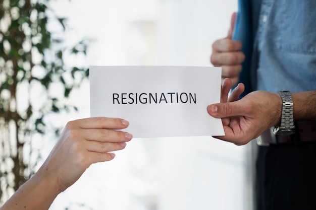 Employee holding resignation letter side view