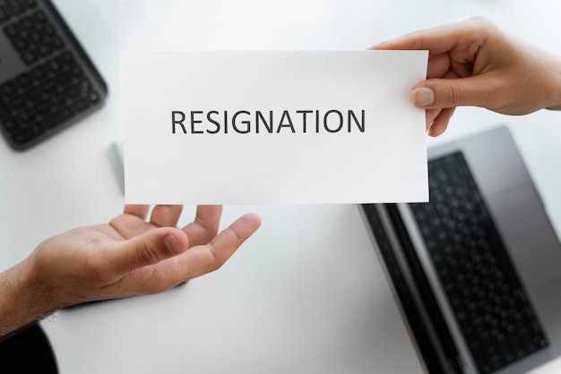 Employee holding resignation letter top view