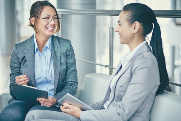 Employee laughing and holding a clipboard