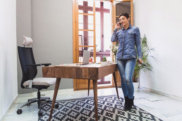 Employee talking on the phone next to her desk