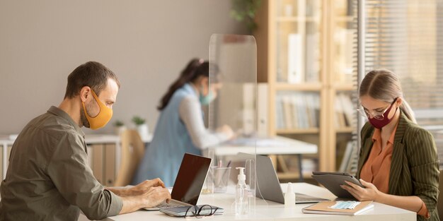 Employees wearing face masks at work