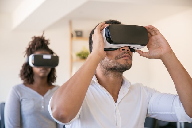 Employees wearing VR glasses and watching virtual presentation