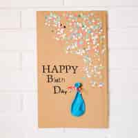 Free photo empty balloon on cardboard with birthday greeting