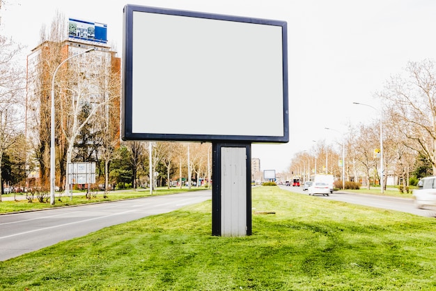 Free photo an empty billboard in the middle of city road