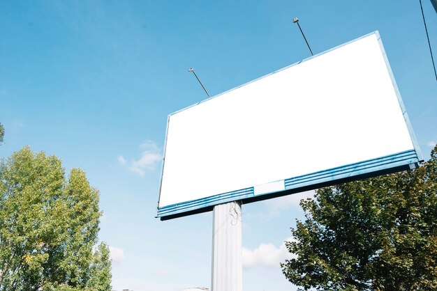 Empty billboard near trees