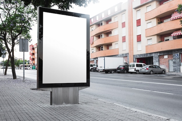 Free photo an empty billboard on the sidewalk near the roadside