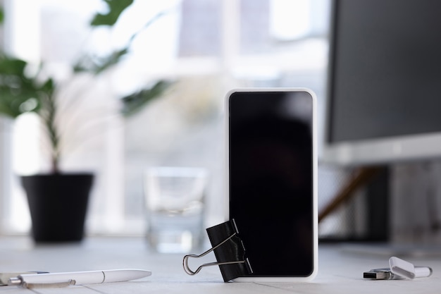 empty black smartphone screen on blured wall. Copyspace, negative space for your advertising, office and business style.