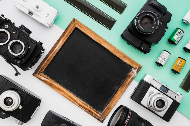 Empty blackboard amidst cameras and film