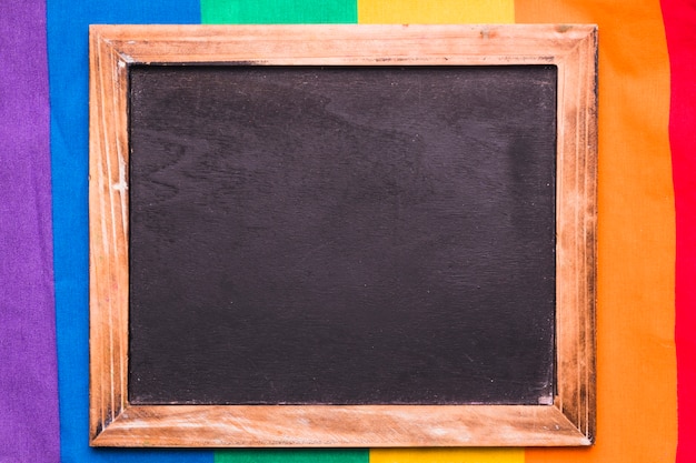 Empty blackboard on rainbow background