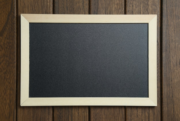 empty blackboard on vintage wooden background