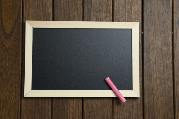 empty blackboard on vintage wooden background