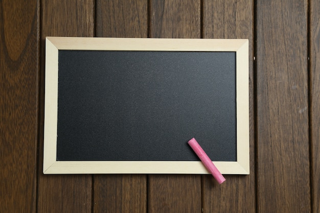 empty blackboard on vintage wooden background