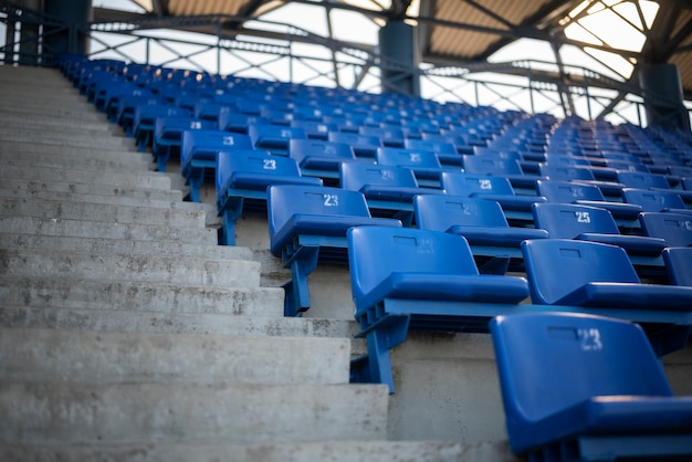 Empty blue grandstands low angle