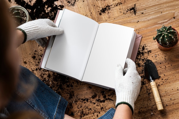 Free photo empty book in the hands of a gardener