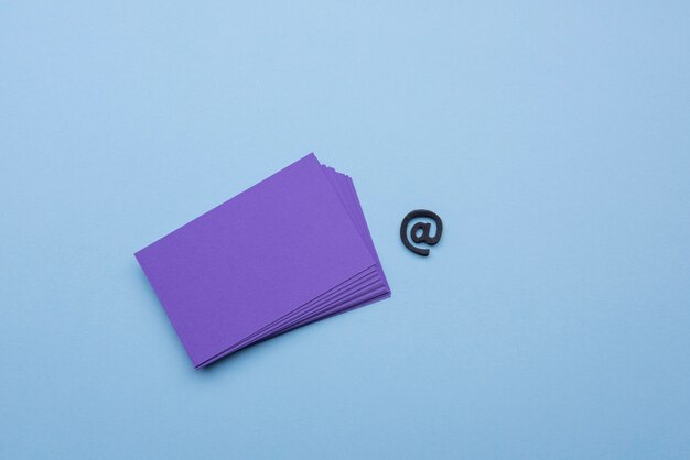 Empty business cards and at sign symbol