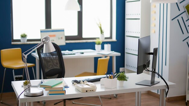 Empty business office with startup technology for economy work, used by employee to create commercial strategy with graphs and charts. No people working in professional startup workspace.