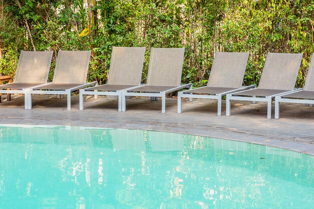 Empty chair around swimming pool in hotel resort