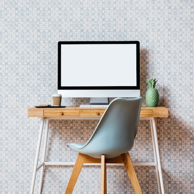 Empty chair in front of computer desktop