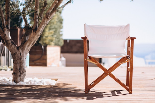 Empty chair under the palm at the beach