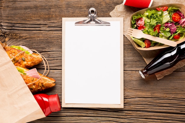 Empty clipboard with fast food and soda