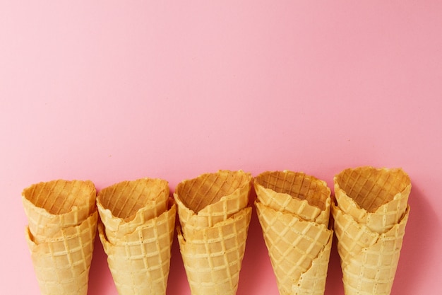 Empty Colorful Pastel Toning Ice Cream Cones on Pink Background. Minimalism. Flat Lay.