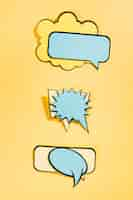 Free photo empty comic speech bubbles on yellow background