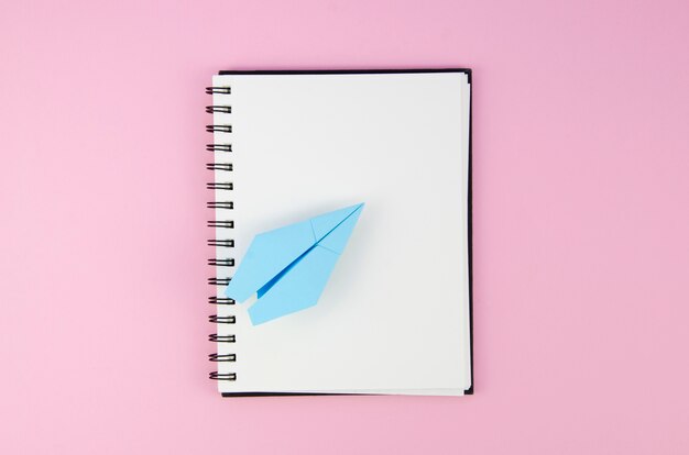 Empty copy space notepad with paper plane