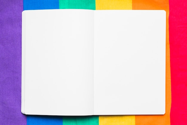 Empty copybook on rainbow background