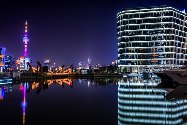 Foto gratuita pavimento vuoto con skyline moderno e costruzioni di notte a shanghai