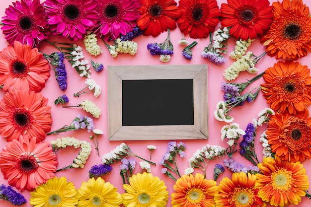 Empty frame in different colorful flowers