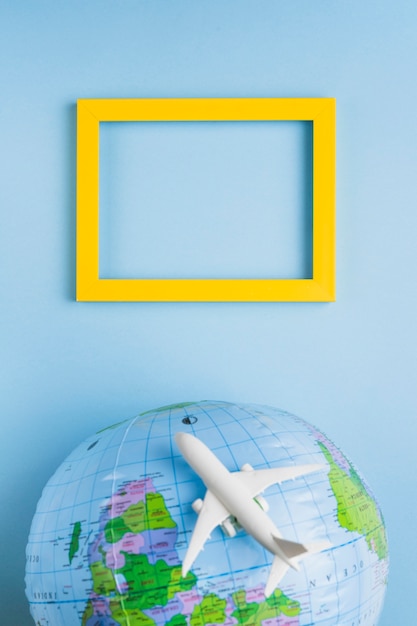 Empty frame, globe and plane