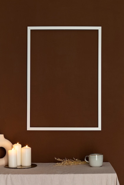 Free photo empty frame and lit candles arrangement