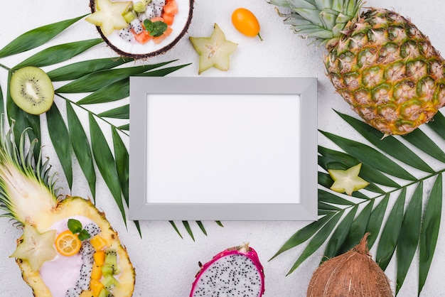 Empty frame surrounded by exotic fruit
