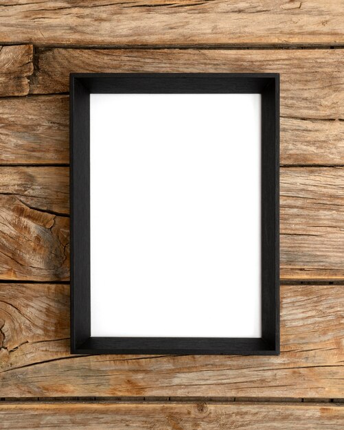 Empty frame on wooden wall