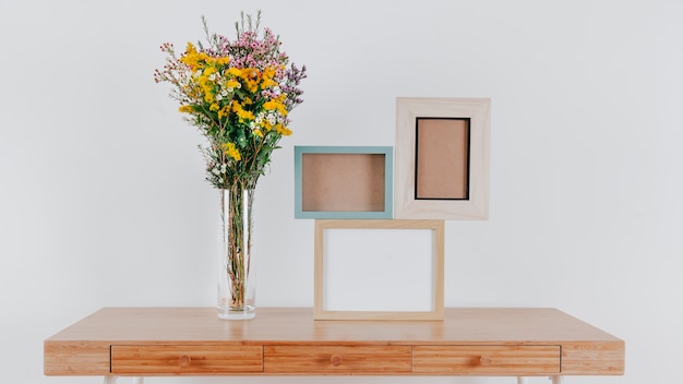 Empty frames on table near flowers