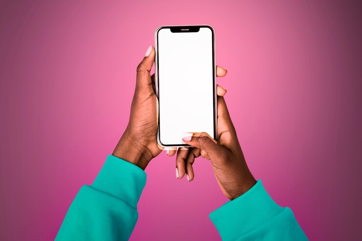 Free Photo empty glowing screen with person holding mobile phone