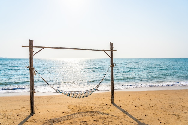 Empty hammock swing on the beautiful beach and sea