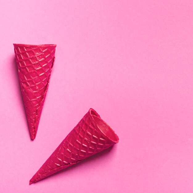 Empty ice cream waffle cones on colored background