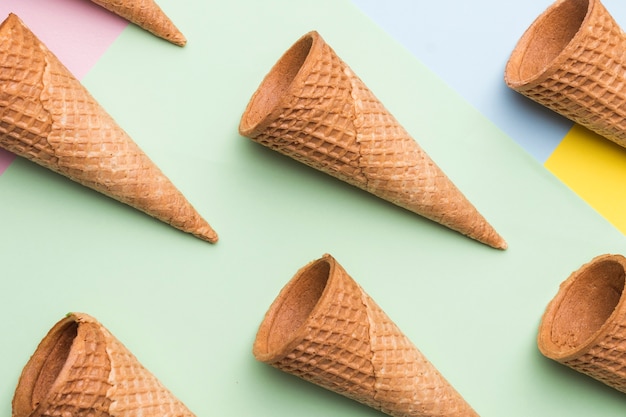 Empty ice cream waffle cones on colourful background