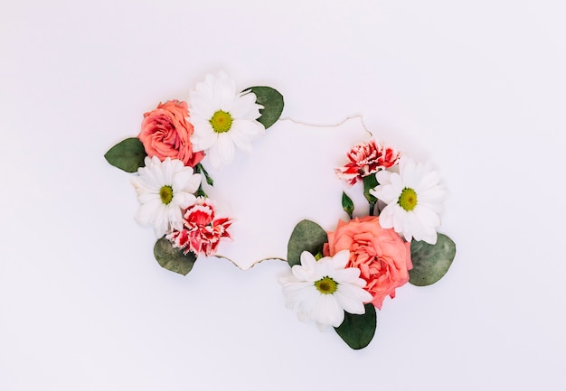 Empty label decorated with flowers and leaves on white backdrop