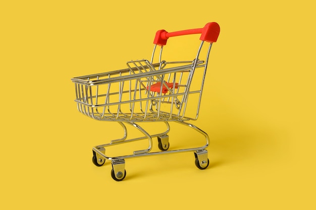 Empty mini shopping basket isolated on yellow background. retail.