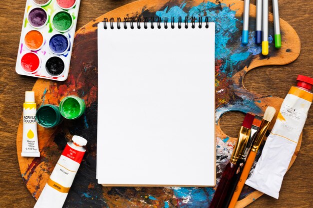 empty notepad above dirty color palette