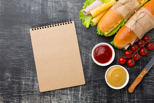 Empty notepad and sandwiches